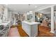 Open concept kitchen with an island, hardwood floors and connected to a dining area at 2329 Club Rd, Charlotte, NC 28205
