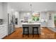 Bright kitchen with stainless steel appliances, a large island, and hardwood floors at 2329 Club Rd, Charlotte, NC 28205
