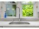 Kitchen sink area featuring a stainless steel sink, faucet, and outside views at 2329 Club Rd, Charlotte, NC 28205