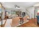 Spacious living room with hardwood floors, a ceiling fan, and staircase access at 2329 Club Rd, Charlotte, NC 28205
