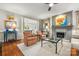 Cozy living room featuring a fireplace, hardwood flooring, and views into the kitchen at 2329 Club Rd, Charlotte, NC 28205