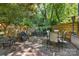 Inviting brick patio surrounded by lush greenery and a stone wall, perfect for outdoor entertaining at 2329 Club Rd, Charlotte, NC 28205