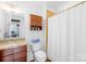 Bright bathroom featuring granite countertop, shower and tub combo, and ample storage space at 2338 Yadkin Ave # D302, Charlotte, NC 28205
