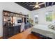 Cozy bedroom with desk, bookshelves, balcony access, and ample natural light at 2338 Yadkin Ave # D302, Charlotte, NC 28205
