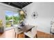 Bright dining area with a modern light fixture, access to the balcony, and a leafy green houseplant at 2338 Yadkin Ave # D302, Charlotte, NC 28205