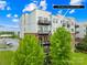 Exterior view of a modern condo building with well-maintained landscaping and balconies at 2338 Yadkin Ave # D302, Charlotte, NC 28205