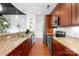 Modern kitchen features stainless steel appliances, granite countertops, and sleek cherry wood cabinetry at 2338 Yadkin Ave # D302, Charlotte, NC 28205