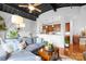 Open-concept living room with a cozy gray sofa, exposed ceiling, and an eat-in kitchen area at 2338 Yadkin Ave # D302, Charlotte, NC 28205