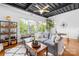 Cozy living room with exposed ceiling, comfortable seating, lots of plants, and bright natural light at 2338 Yadkin Ave # D302, Charlotte, NC 28205