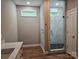 Well-lit bathroom featuring a shower with glass door and tiled wall at 2442 Falcon Ln, Statesville, NC 28625