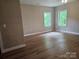 Bright and airy bedroom featuring hard wood floors and two bright windows at 2442 Falcon Ln, Statesville, NC 28625