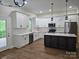 Spacious kitchen featuring white cabinets, stainless steel appliances, and an island at 2442 Falcon Ln, Statesville, NC 28625