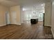 Spacious living room featuring hardwood floors and modern lighting, transitioning to an open kitchen at 2442 Falcon Ln, Statesville, NC 28625