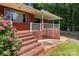 View of the back porch with white railing and steps leading up to the home at 24501 Canton Rd, Albemarle, NC 28001
