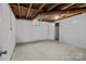 Clean unfinished basement with painted walls, concrete floor, and small window at 24501 Canton Rd, Albemarle, NC 28001