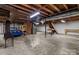 Spacious unfinished basement featuring concrete floor, exposed ceiling and brick accent wall at 24501 Canton Rd, Albemarle, NC 28001
