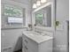 Cozy bathroom featuring a white vanity, mirror, and natural light from the window at 24501 Canton Rd, Albemarle, NC 28001