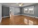Bright bedroom featuring hardwood floors, ceiling fan and natural light from the windows at 24501 Canton Rd, Albemarle, NC 28001