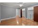 Bright bedroom featuring hardwood floors, ceiling fan and closet space at 24501 Canton Rd, Albemarle, NC 28001