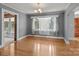 Open dining room featuring hardwood floors, a chandelier, and large windows at 24501 Canton Rd, Albemarle, NC 28001