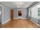 Well-lit dining room featuring hardwood floors, a chandelier, and large windows at 24501 Canton Rd, Albemarle, NC 28001