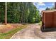 Long, paved driveway leading to the side of the brick home at 24501 Canton Rd, Albemarle, NC 28001