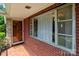 Charming front porch with brick detail and tiled floor welcomes you home at 24501 Canton Rd, Albemarle, NC 28001