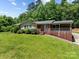 Charming brick home with stone accents, landscaped yard and a covered front porch perfect for relaxing at 24501 Canton Rd, Albemarle, NC 28001
