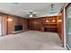 Gathering room featuring a brick fireplace, built-in shelves, and a neutral carpet at 24501 Canton Rd, Albemarle, NC 28001
