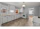 Charming kitchen with white cabinetry, a window over the sink, and easy-to-clean tile floors at 24501 Canton Rd, Albemarle, NC 28001