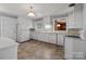 Functional kitchen with white cabinets, updated appliances, and tile flooring at 24501 Canton Rd, Albemarle, NC 28001