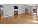 Open living room featuring hardwood floors, a ceiling fan, and a fireplace at 24501 Canton Rd, Albemarle, NC 28001