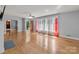 Bright living room featuring hardwood floors, fireplace, and multiple windows at 24501 Canton Rd, Albemarle, NC 28001