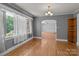 Open living room featuring hardwood floors, natural light, and an arched doorway to the Gathering room at 24501 Canton Rd, Albemarle, NC 28001