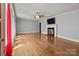 Spacious living room featuring hardwood floors, a ceiling fan, and a fireplace at 24501 Canton Rd, Albemarle, NC 28001