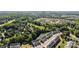 Aerial view of a residential neighborhood featuring townhomes, lush green trees, and a tranquil pond at 2665 Grantham Place Dr, Fort Mill, SC 29715