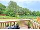 Scenic back deck overlooking a tranquil pond and lush landscaping, ideal for peaceful outdoor enjoyment at 2665 Grantham Place Dr, Fort Mill, SC 29715
