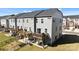 Rear exterior view of townhomes featuring wooden decks, patios, and green lawn areas with fencing at 2665 Grantham Place Dr, Fort Mill, SC 29715
