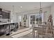 Bright, open-concept kitchen and dining area featuring modern fixtures, stainless steel appliances, and a sliding glass door to the deck at 2665 Grantham Place Dr, Fort Mill, SC 29715