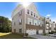 Two-story townhome featuring gray siding, a brick foundation, an attached two-car garage, and a well-maintained lawn at 2665 Grantham Place Dr, Fort Mill, SC 29715