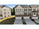 Charming townhome featuring a brick and siding exterior, well-manicured lawn, and a two-car garage with inviting curb appeal at 2665 Grantham Place Dr, Fort Mill, SC 29715
