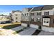 Exterior view of townhomes with attached two-car garages, gray siding, and well-manicured lawns on a sunny day at 2665 Grantham Place Dr, Fort Mill, SC 29715