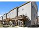 Exterior view of townhomes with wooden decks and patios, complemented by well-maintained yards and landscaping at 2665 Grantham Place Dr, Fort Mill, SC 29715