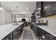Modern kitchen with dark cabinets, stainless steel appliances, quartz countertops, and an island with a sink at 2665 Grantham Place Dr, Fort Mill, SC 29715