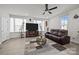Comfortable living room with ample natural light, modern decor, a large TV, and hardwood flooring at 2665 Grantham Place Dr, Fort Mill, SC 29715