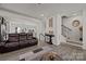 Open-concept living room featuring a staircase, hardwood floors, stylish decor, and an open view to the kitchen at 2665 Grantham Place Dr, Fort Mill, SC 29715
