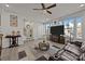 Bright living room with modern decor, hardwood floors, large TV, and a comfortable brown leather sofa at 2665 Grantham Place Dr, Fort Mill, SC 29715