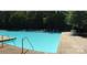 A well-maintained community pool surrounded by lounge chairs and lush greenery at 2665 Grantham Place Dr, Fort Mill, SC 29715