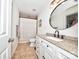 Bathroom featuring a white vanity with granite countertop and shower with tile surround at 2715 Selwyn Ave # 36, Charlotte, NC 28209