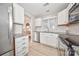 Bright kitchen featuring white cabinetry, stainless steel appliances, and granite countertops at 2715 Selwyn Ave # 36, Charlotte, NC 28209